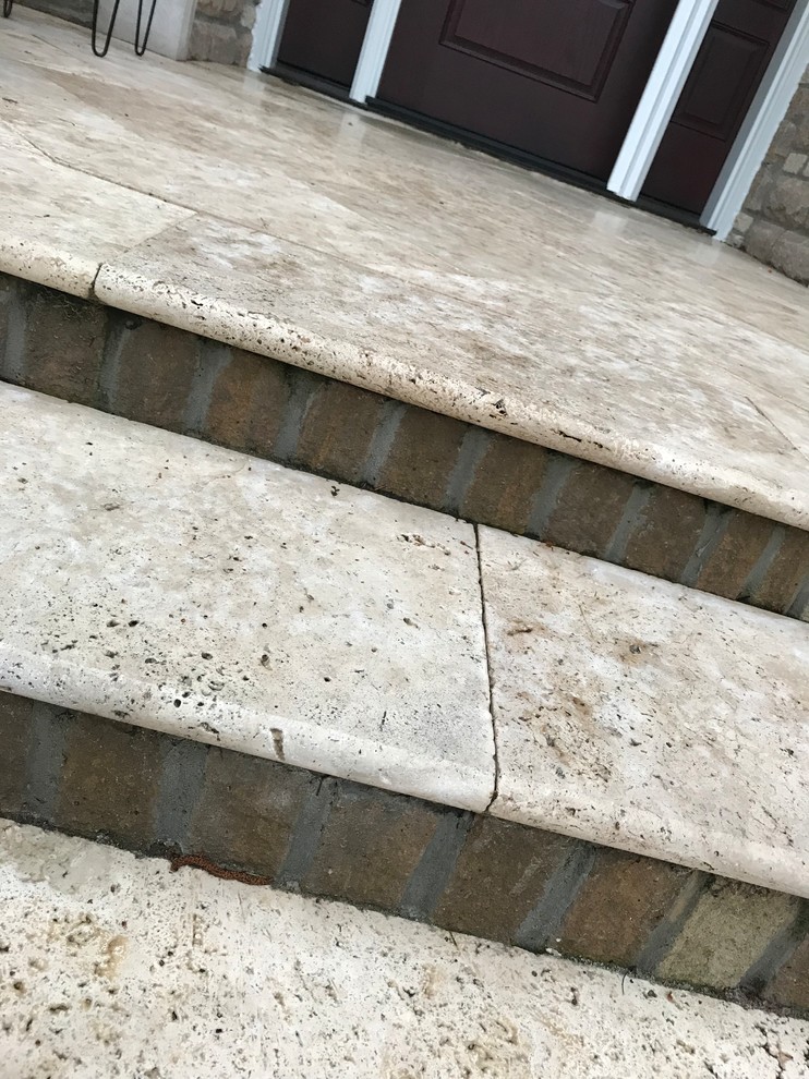 Inspiration for a mid-sized timeless tile front porch remodel