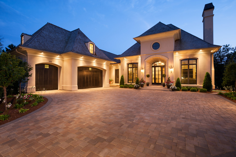 Inspiration for a large mediterranean beige one-story stucco house exterior remodel in Minneapolis