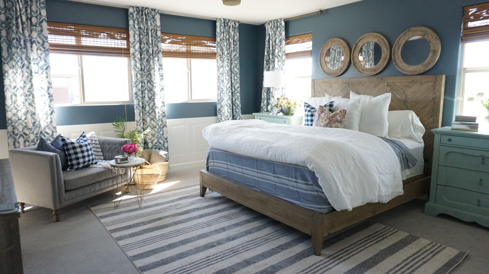 Design ideas for a mid-sized arts and crafts master bedroom in Phoenix with blue walls, carpet and beige floor.