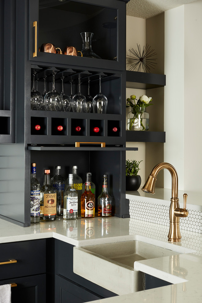 Inspiration for a large transitional u-shaped home bar in Minneapolis with an undermount sink, recessed-panel cabinets, black cabinets, quartz benchtops, white splashback and subway tile splashback.