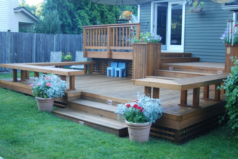 This is an example of a mid-sized traditional backyard deck in Seattle with no cover.
