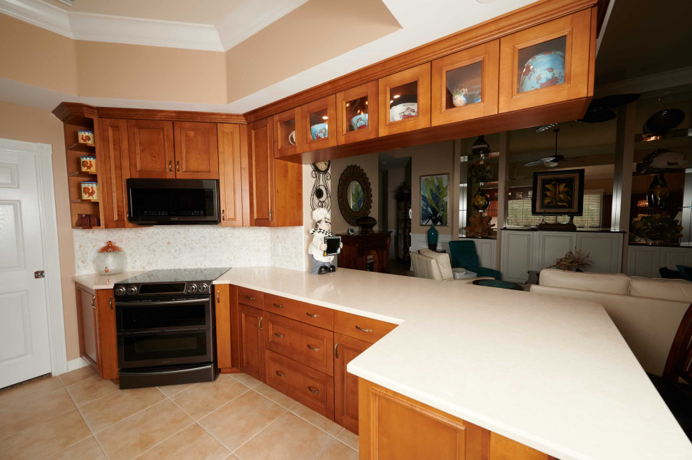 Kitchen - mid-sized transitional galley porcelain tile, beige floor and tray ceiling kitchen idea with a farmhouse sink, recessed-panel cabinets, medium tone wood cabinets, quartz countertops, multicolored backsplash, marble backsplash, stainless steel appliances, a peninsula and beige countertops