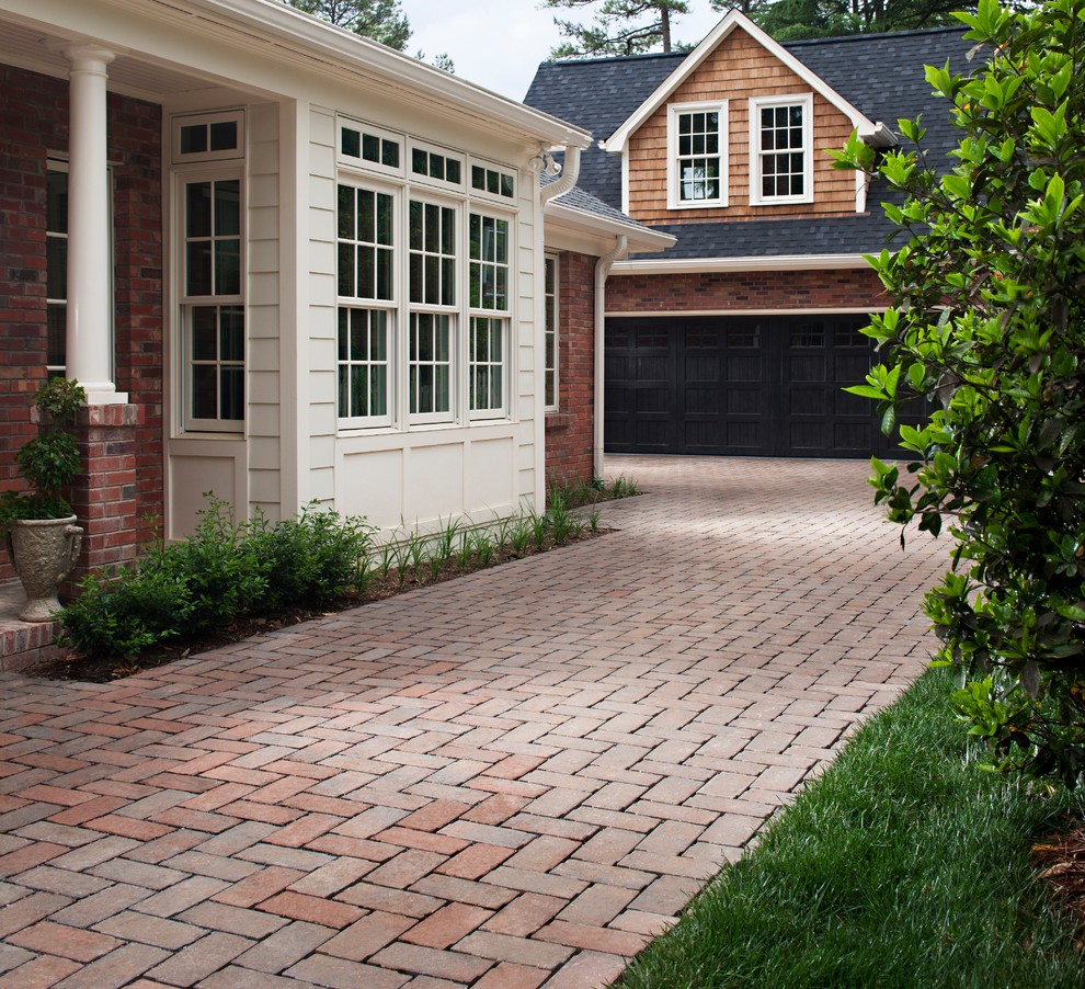 Design ideas for a mid-sized transitional front yard partial sun driveway in Oklahoma City with brick pavers.