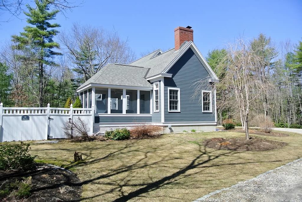 This is an example of a mid-sized traditional two-storey blue exterior in Boston with vinyl siding and a gable roof.
