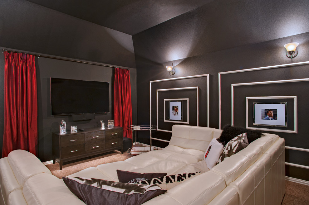 This is an example of a large eclectic enclosed home theatre in Austin with black walls, carpet and a wall-mounted tv.