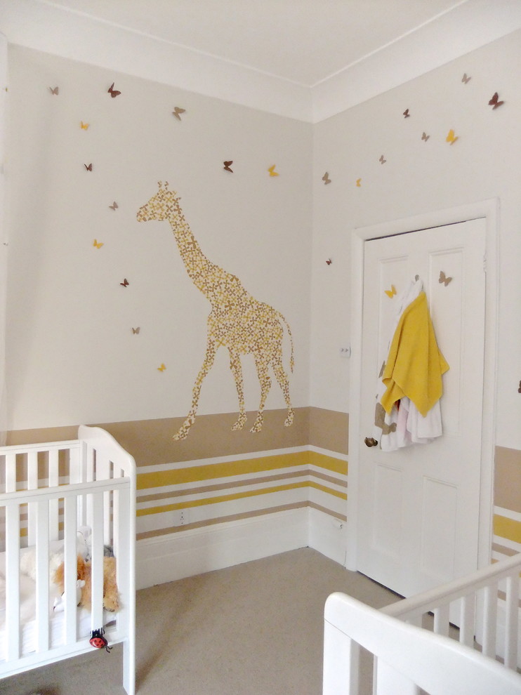 This is an example of a large eclectic nursery for girls in London with carpet.