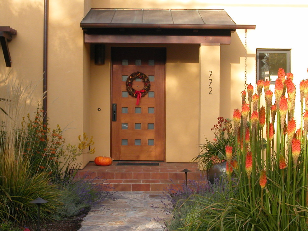 This is an example of a contemporary front door in San Francisco with a single front door and a medium wood front door.