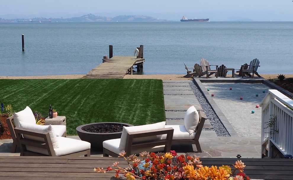 Beach style backyard garden in San Francisco with a fire feature and decking.