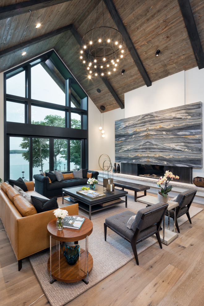 Inspiration for a large contemporary formal open concept living room in Minneapolis with white walls, light hardwood floors, a ribbon fireplace, no tv, brown floor and a wood fireplace surround.