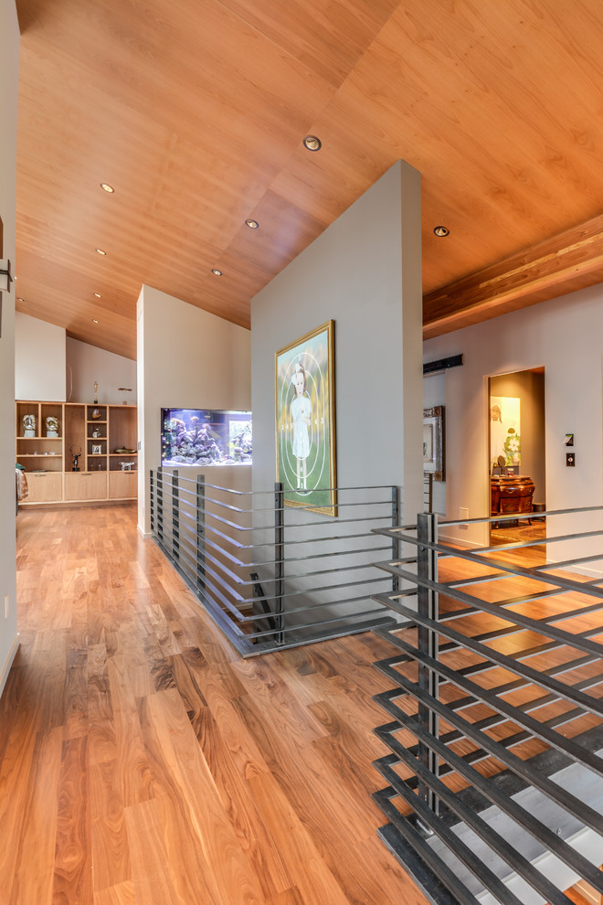 Mid-sized minimalist medium tone wood floor hallway photo in Seattle with multicolored walls