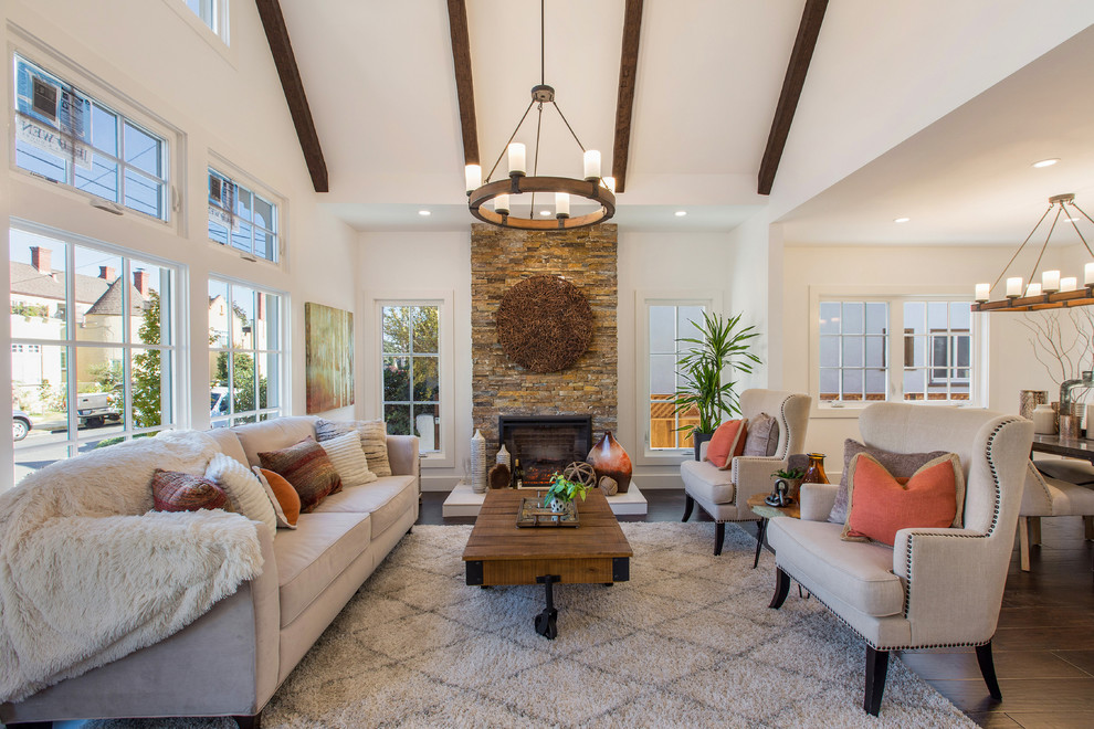 Inspiration for a country open concept living room in Other with white walls, dark hardwood floors, a standard fireplace, a stone fireplace surround and brown floor.