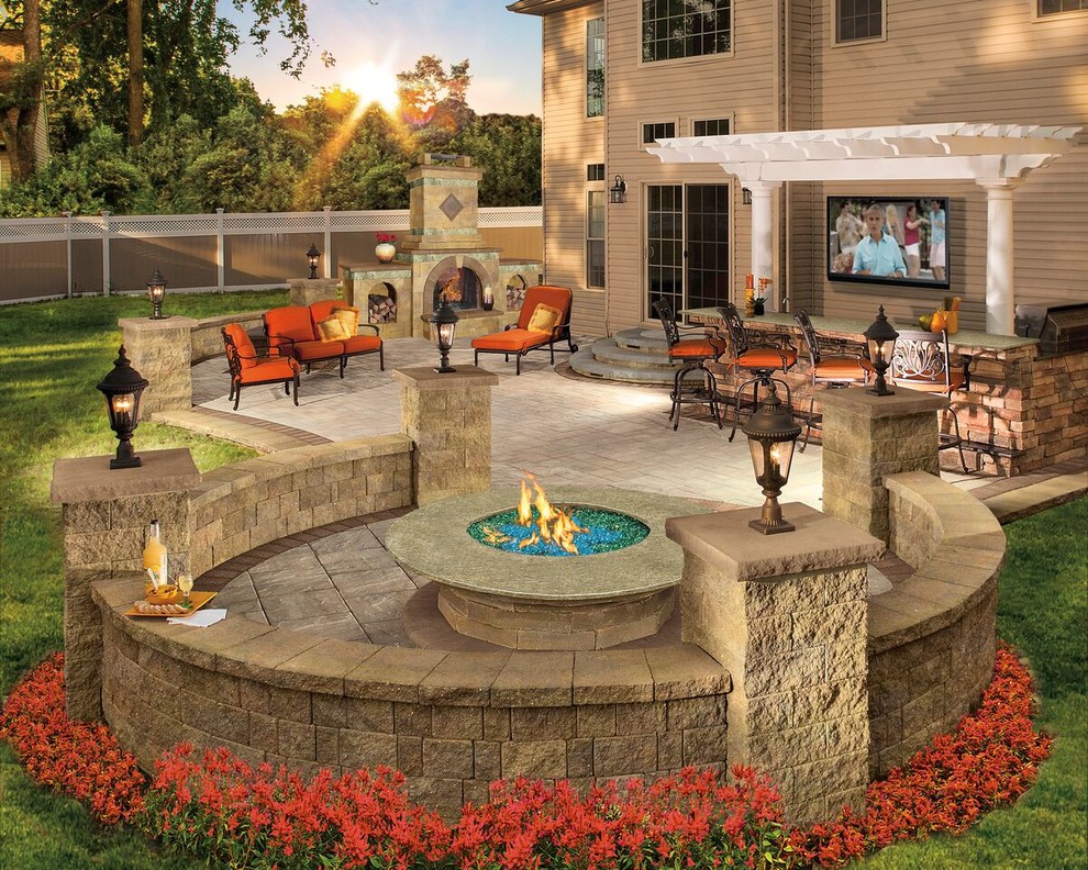 Photo of a large contemporary backyard patio in New York with a fire feature, natural stone pavers and a pergola.