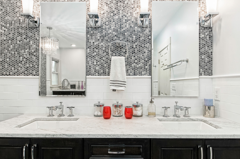 Inspiration for a mid-sized contemporary bathroom in Columbus with recessed-panel cabinets, black cabinets, a claw-foot tub, white tile, subway tile, grey walls, porcelain floors, an undermount sink and grey floor.