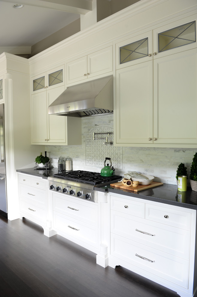 Large transitional u-shaped dark wood floor eat-in kitchen photo in Vancouver with a farmhouse sink, recessed-panel cabinets, white cabinets, glass countertops, white backsplash, stainless steel appliances and no island