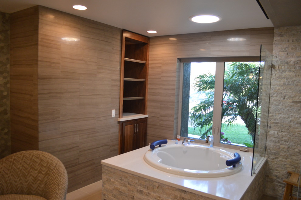 Design ideas for a large contemporary master bathroom in Los Angeles with dark wood cabinets, a drop-in tub, a corner shower, beige tile, gray tile and beige walls.