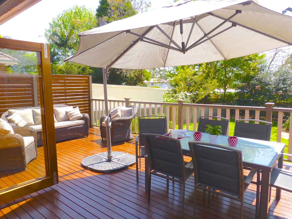 This is an example of a mid-sized transitional backyard deck in Sydney with no cover.