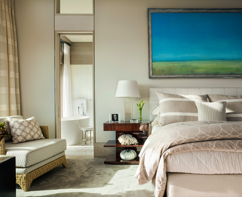 Photo of a large beach style master bedroom in Boston with beige walls, light hardwood floors and no fireplace.