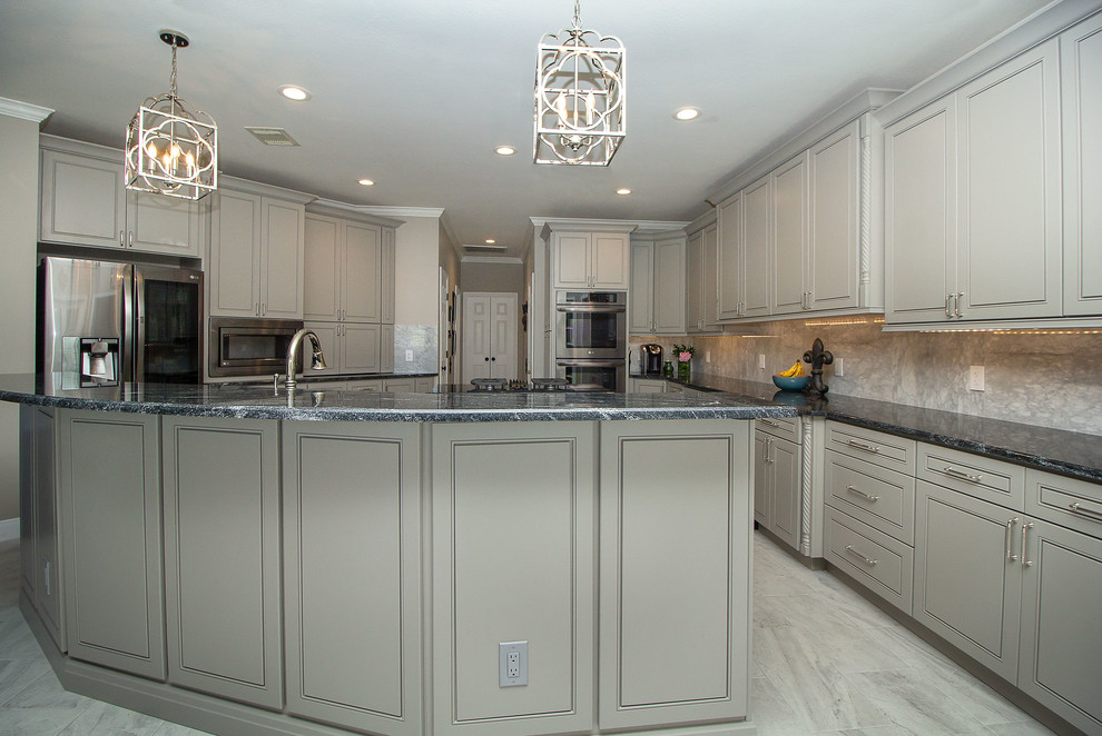 Example of a large transitional l-shaped porcelain tile and white floor eat-in kitchen design in Houston with a single-bowl sink, beaded inset cabinets, gray cabinets, granite countertops, white backsplash, marble backsplash, stainless steel appliances, two islands and black countertops