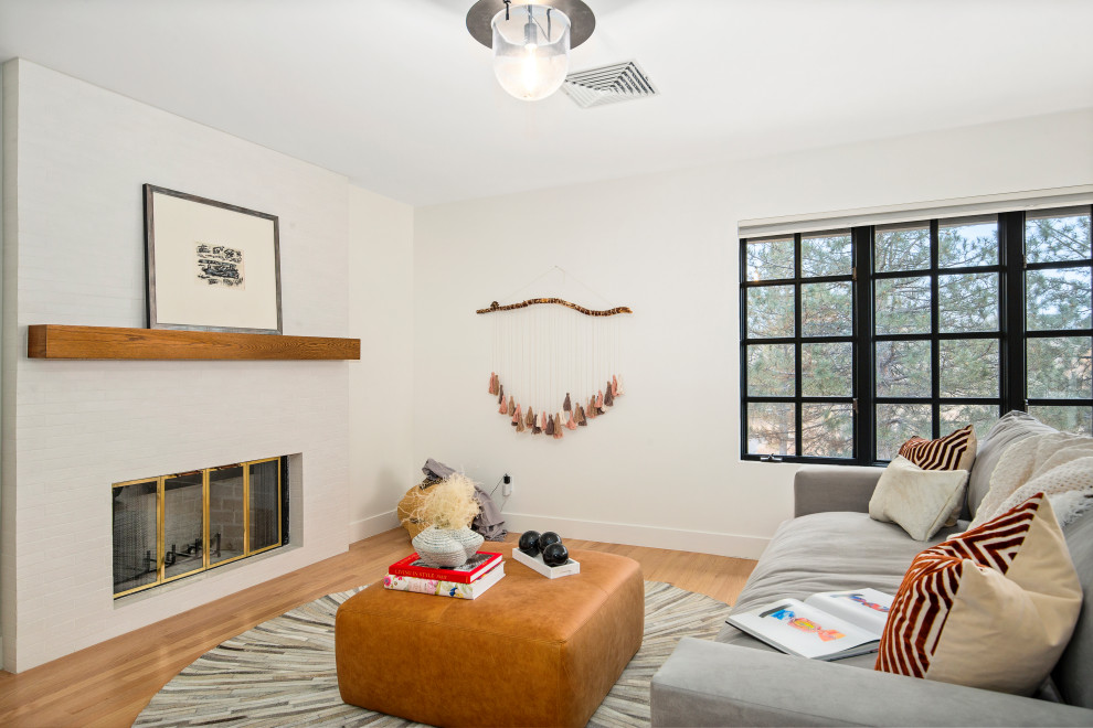 Mittelgroßes, Fernseherloses Modernes Wohnzimmer ohne Kamin, im Loft-Stil mit weißer Wandfarbe und braunem Holzboden in Santa Barbara