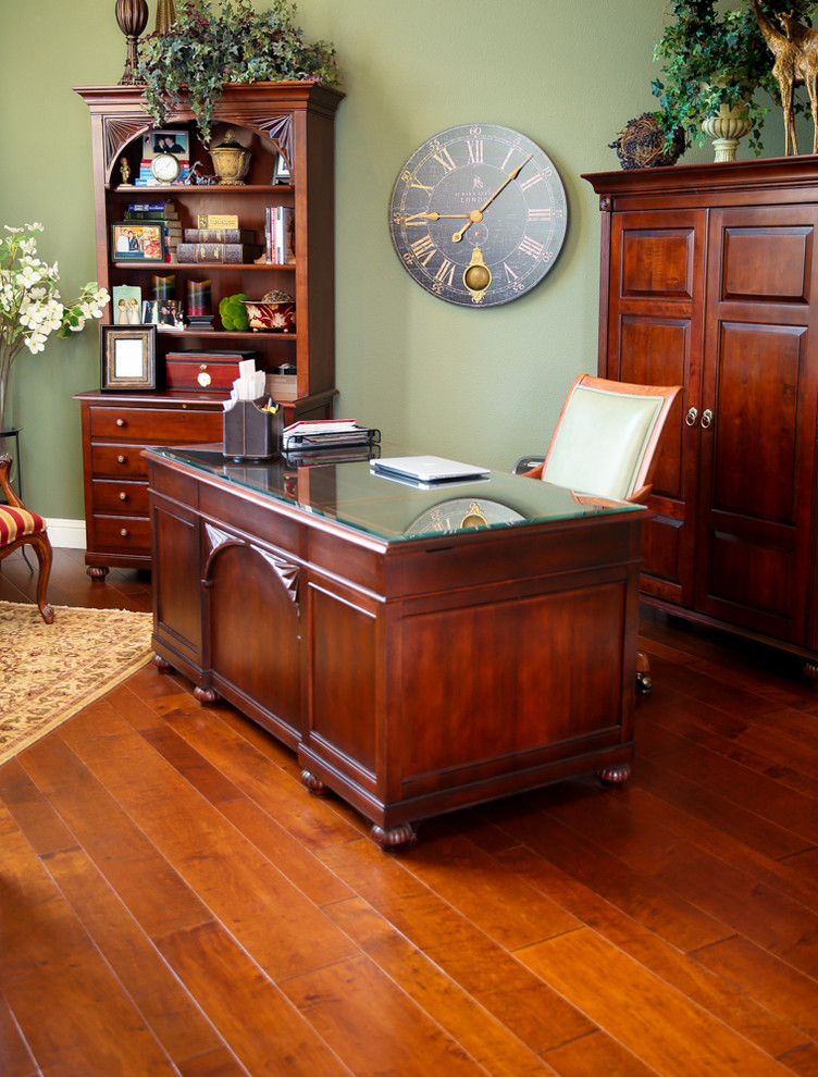 Inspiration for a large traditional study room in Other with brown floor, no fireplace, green walls, medium hardwood floors and a freestanding desk.