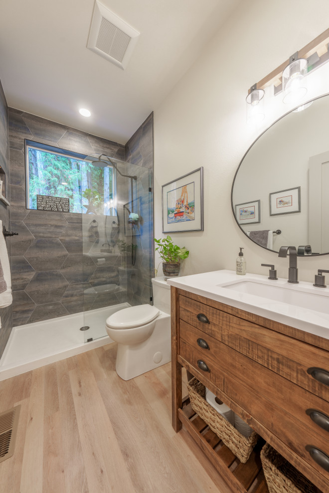 Photo of a large contemporary 3/4 bathroom in Seattle with flat-panel cabinets, dark wood cabinets, an alcove shower, a one-piece toilet, gray tile, ceramic tile, white walls, vinyl floors, a drop-in sink, marble benchtops, beige floor, a hinged shower door, white benchtops, an enclosed toilet, a single vanity, a floating vanity and exposed beam.