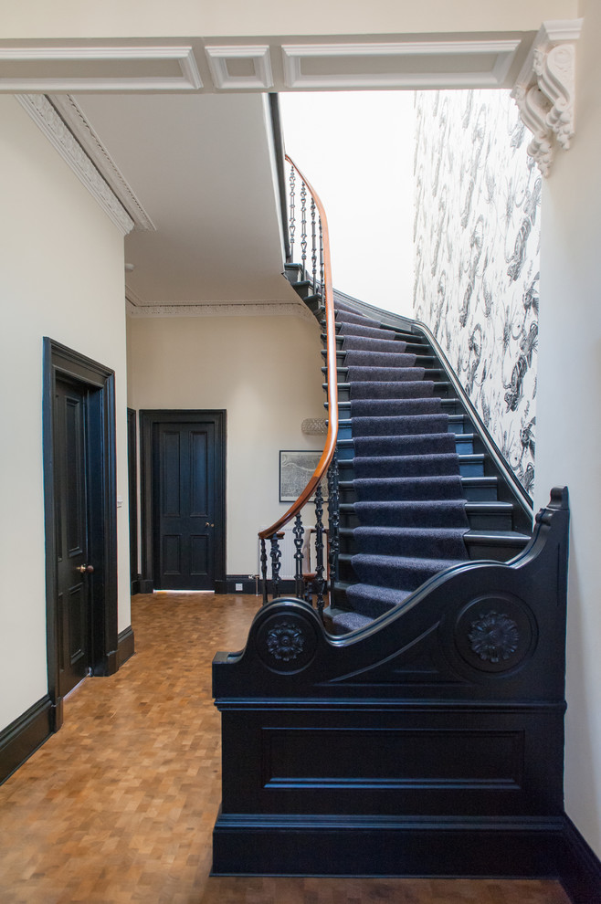 Photo of an eclectic wood curved staircase in Glasgow with wood risers.