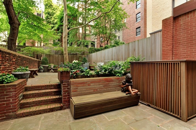 This is an example of a mid-sized traditional backyard patio in New York with a vegetable garden, concrete pavers and no cover.