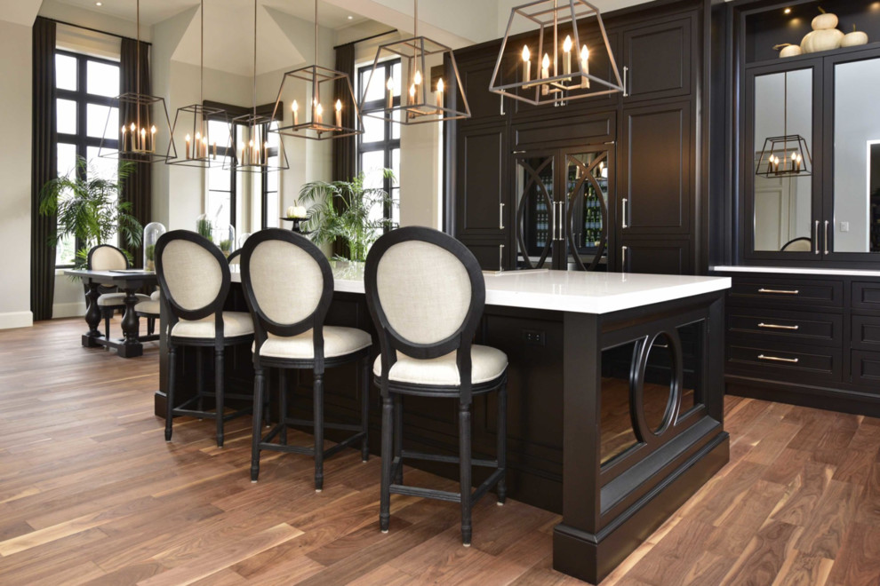 Example of a large transitional l-shaped medium tone wood floor and brown floor eat-in kitchen design with an undermount sink, recessed-panel cabinets, black cabinets, marble countertops, multicolored backsplash, cement tile backsplash, paneled appliances and an island