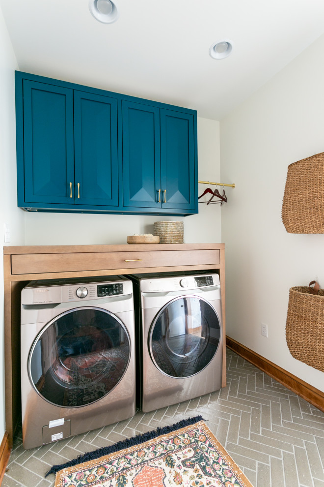 This is an example of a midcentury laundry room in Cleveland.