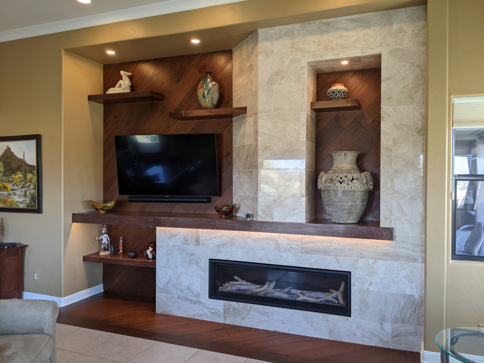 This is an example of a medium sized classic open plan games room in Phoenix with medium hardwood flooring, all types of fireplace, a stone fireplace surround, a wall mounted tv and wood walls.