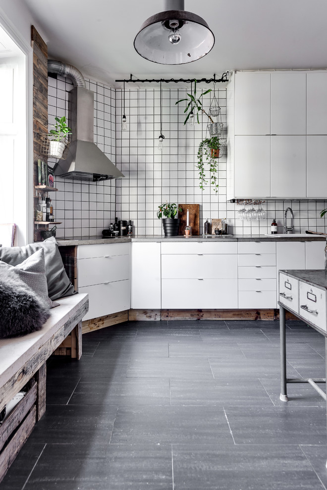 Design ideas for a large industrial single-wall kitchen in Stockholm with flat-panel cabinets, white cabinets, granite benchtops, porcelain splashback, limestone floors and no island.