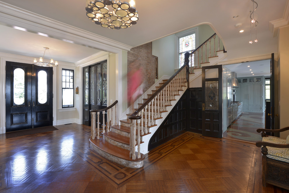 Large traditional foyer in New York with a double front door, a glass front door, white walls and medium hardwood floors.