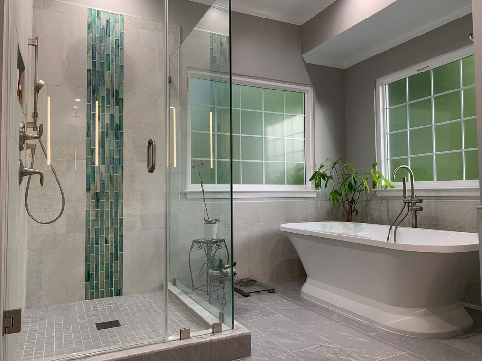 Inspiration for a mid-sized modern master bathroom in DC Metro with furniture-like cabinets, white cabinets, a freestanding tub, a corner shower, a one-piece toilet, gray tile, porcelain tile, grey walls, porcelain floors, an undermount sink, granite benchtops, grey floor, a hinged shower door and grey benchtops.