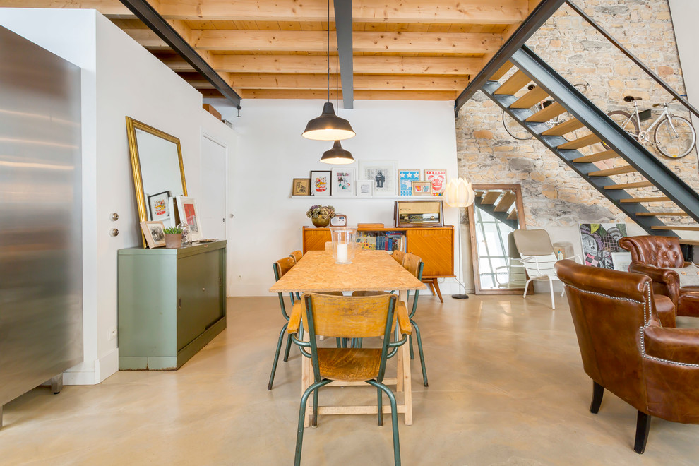 Photo of a mid-sized industrial open plan dining in Lyon with white walls and no fireplace.
