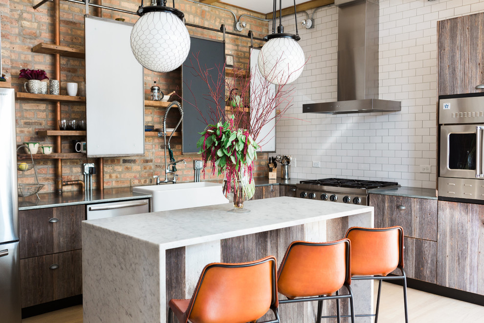 Industrial l-shaped kitchen in Chicago with a farmhouse sink, open cabinets, white splashback, subway tile splashback, stainless steel appliances, light hardwood floors, with island and beige floor.