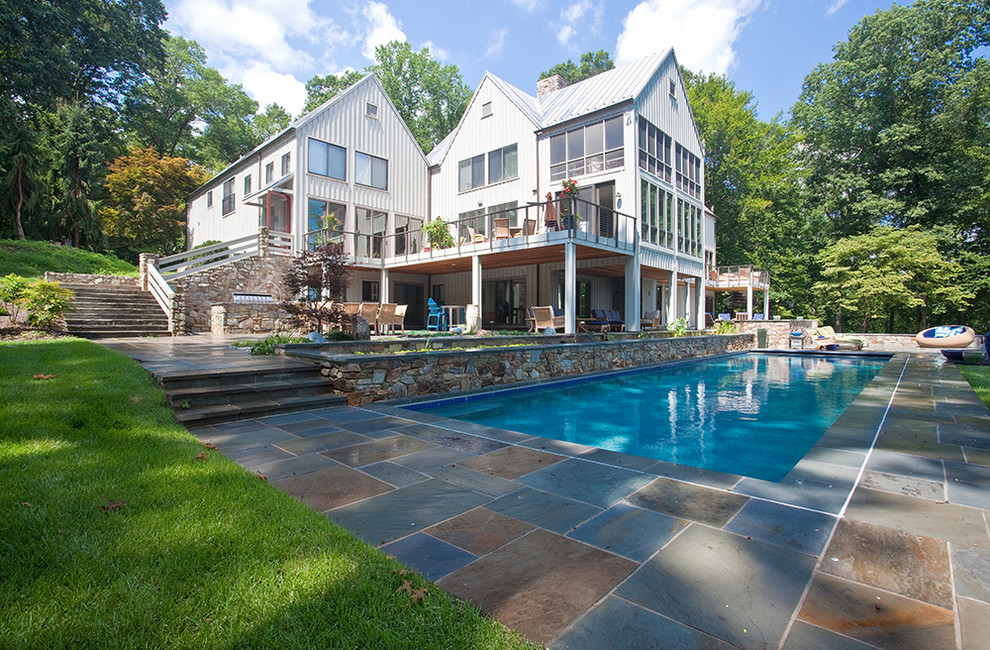 This is an example of a large traditional backyard rectangular lap pool in Baltimore with tile.