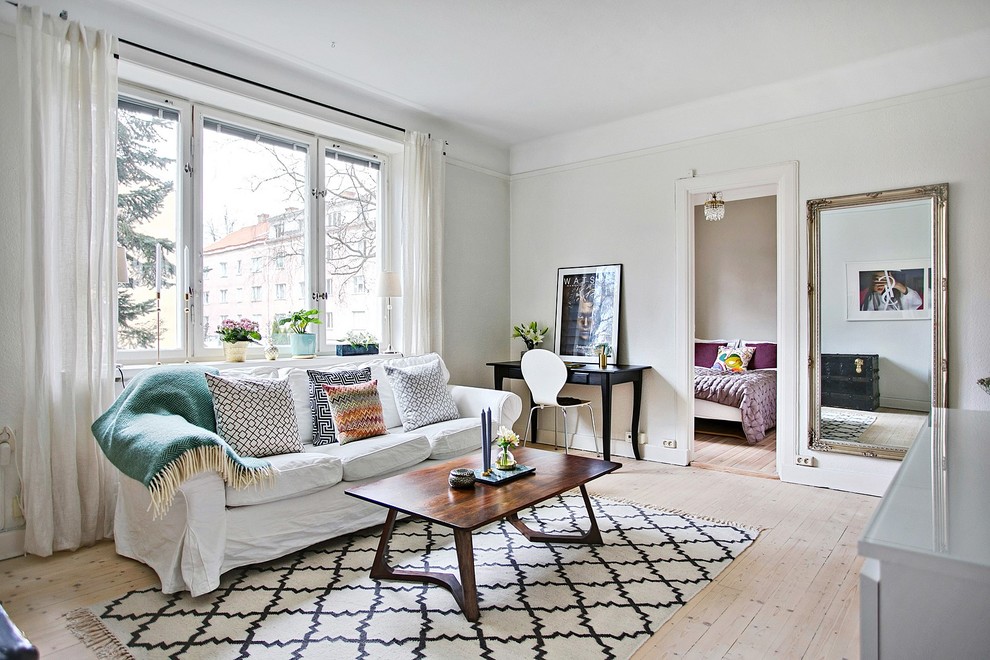 Photo of a mid-sized scandinavian formal open concept living room in Other with grey walls, light hardwood floors, no fireplace and no tv.