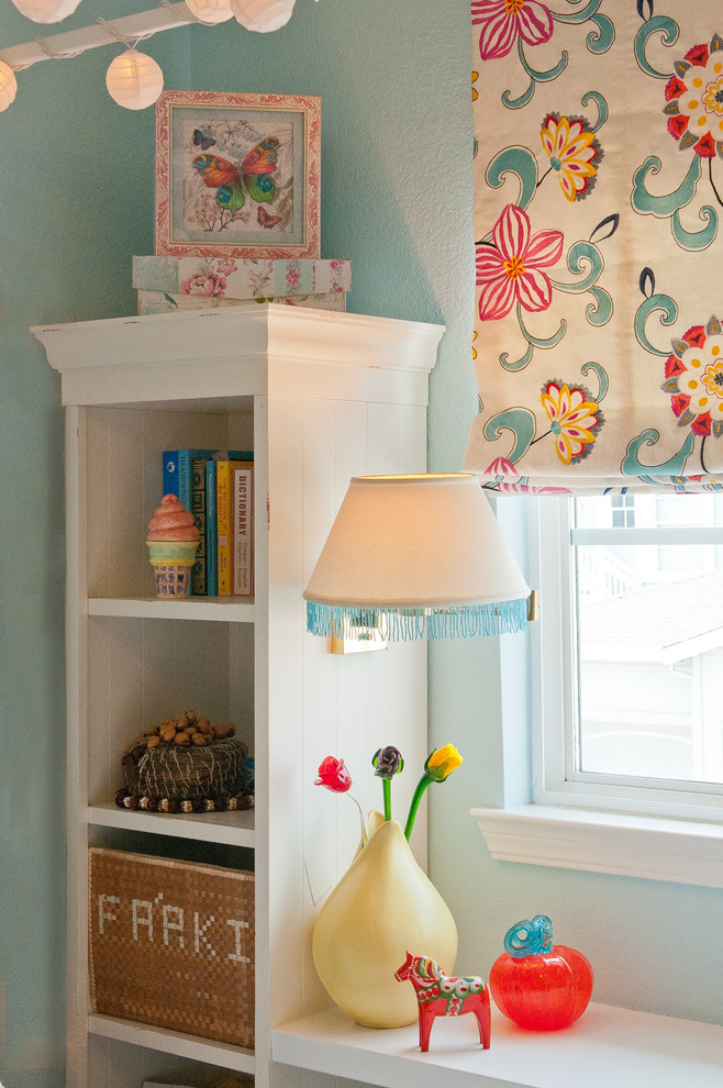 Inspiration for a small eclectic kids' room for girls in San Francisco with blue walls and carpet.