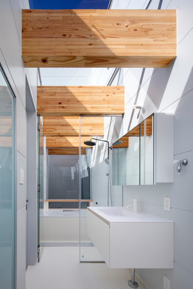 Photo of a world-inspired bathroom in Other with beaded cabinets, white cabinets, a built-in bath, white walls, an integrated sink, white floors, white worktops, a single sink and a floating vanity unit.