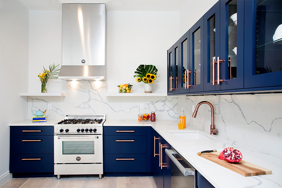 Inspiration for a contemporary l-shaped kitchen in New York with an undermount sink, flat-panel cabinets, blue cabinets, white splashback, stainless steel appliances, light hardwood floors, no island and beige floor.