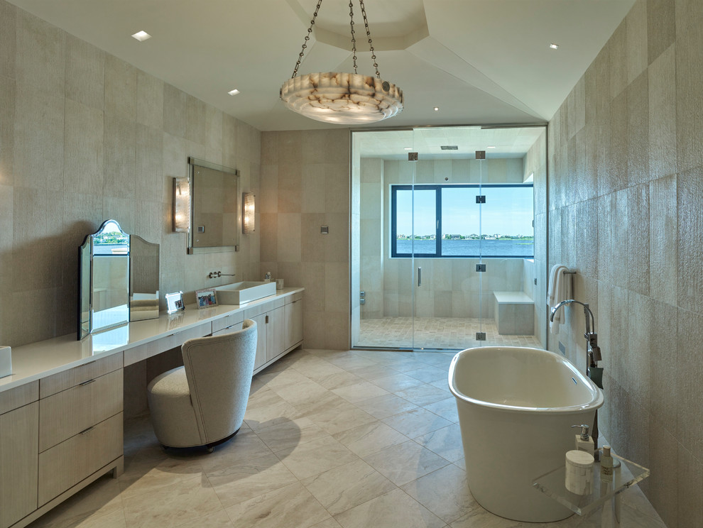Mediterranean master bathroom in Dallas with flat-panel cabinets, light wood cabinets, a freestanding tub, an alcove shower, beige tile, beige walls, a vessel sink, beige floor, a hinged shower door and yellow benchtops.