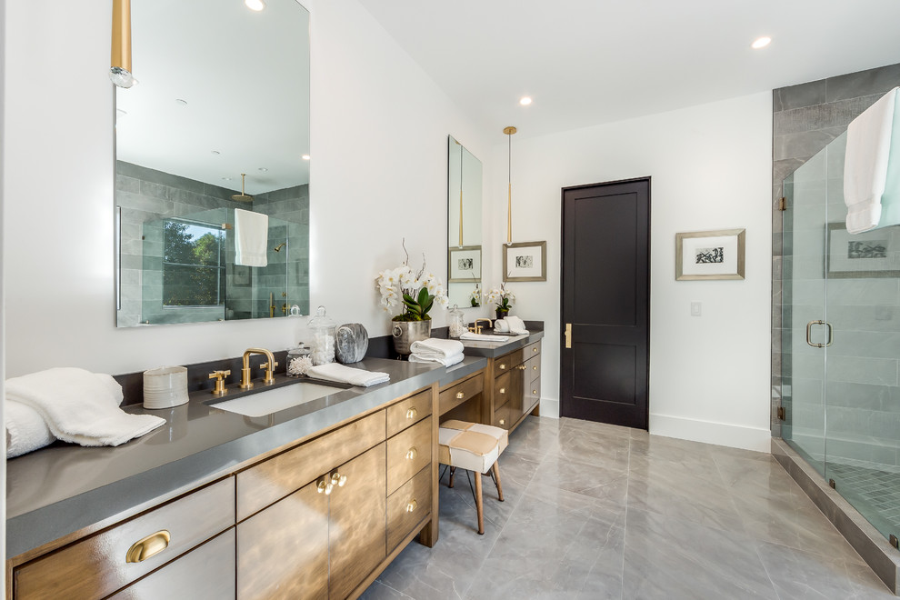 Photo of a large transitional master bathroom in Los Angeles with shaker cabinets, brown cabinets, white walls, marble floors, a drop-in sink, grey floor, grey benchtops, gray tile, soapstone benchtops, a claw-foot tub, an alcove shower, a hinged shower door, a one-piece toilet and ceramic tile.