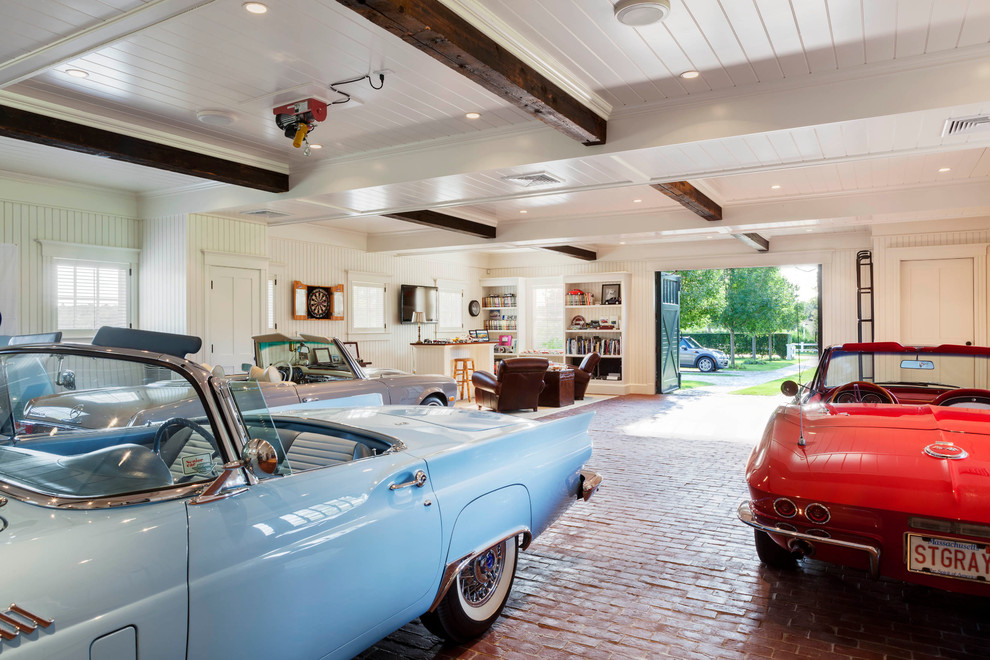 Photo of an expansive beach style four-car garage in Boston.