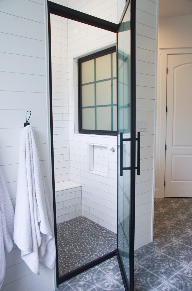 Large transitional master porcelain tile, gray floor and double-sink freestanding bathtub photo with a two-piece toilet, white walls, a drop-in sink, wood countertops, a hinged shower door, brown countertops, a niche and a freestanding vanity