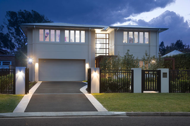Design ideas for a contemporary two-storey stucco white exterior in Sydney with a hip roof.