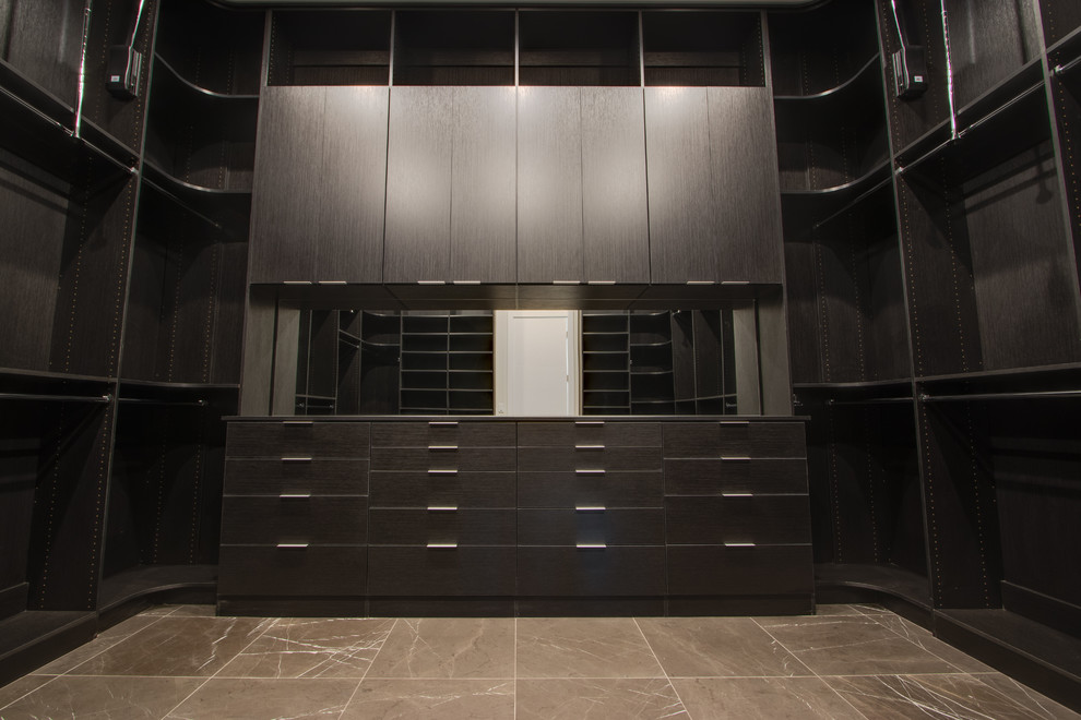 Photo of a large contemporary walk-in wardrobe in Las Vegas with flat-panel cabinets and black cabinets.