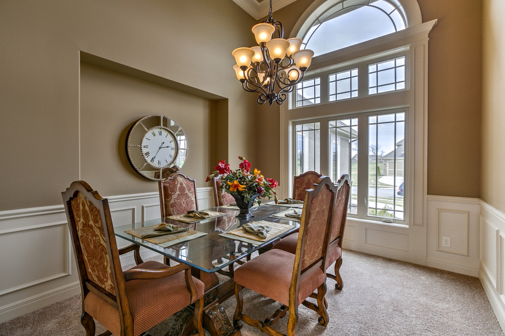Traditional dining room in Kansas City with beige walls and carpet.