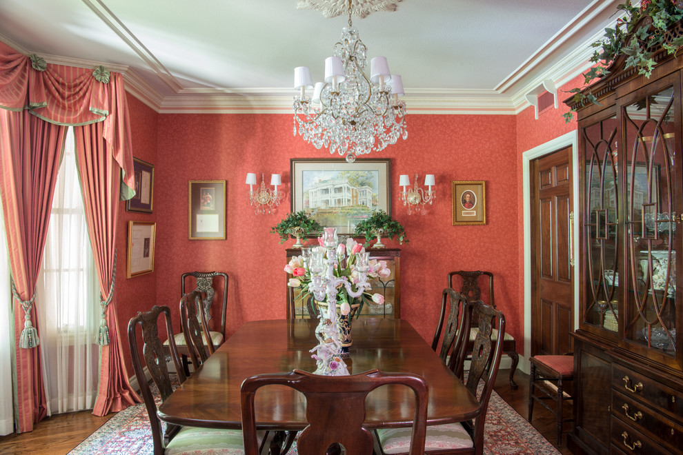 Inspiration for a mid-sized traditional dining room in Other with red walls.