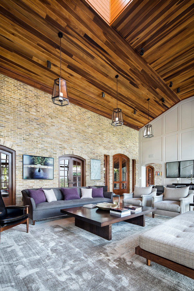 This is an example of a large contemporary formal open concept living room in Austin with beige walls, marble floors, a standard fireplace, a stone fireplace surround and a concealed tv.