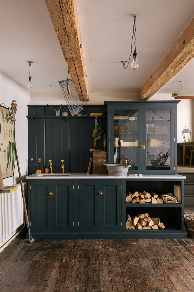 This is an example of a mid-sized country kitchen in Other with an undermount sink, glass-front cabinets, blue cabinets, blue splashback, dark hardwood floors and brown floor.